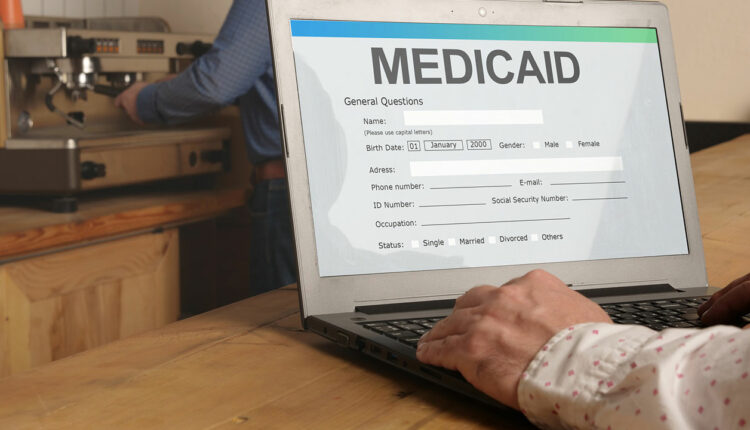 Laptop displaying a Medicaid form, highlighting expanded dental coverage and access to oral health care.